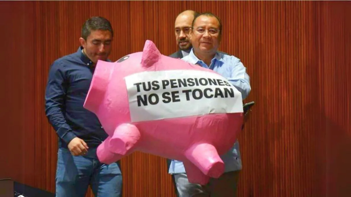 Roberto Valenzuela, diputado del PAN, carga un “cochinito” de cartón con la frase “Tus pensiones no se tocan”. Foto: Cuartoscuro.